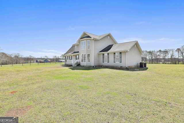 view of front of house with a front lawn, central air condition unit, and crawl space