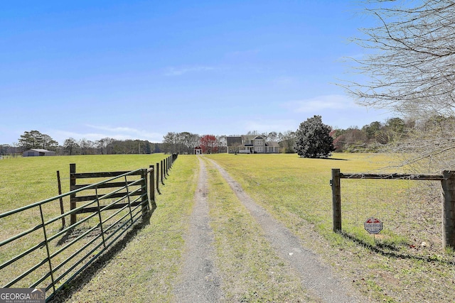 view of street with a rural view and driveway