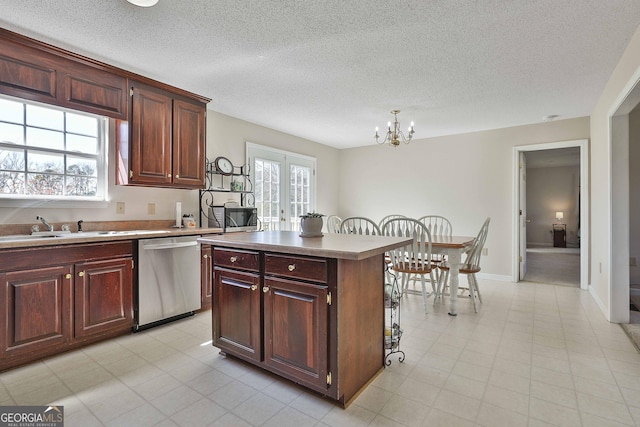 kitchen with plenty of natural light, dishwasher, a kitchen island, and french doors