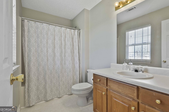 bathroom with visible vents, toilet, curtained shower, a textured ceiling, and vanity