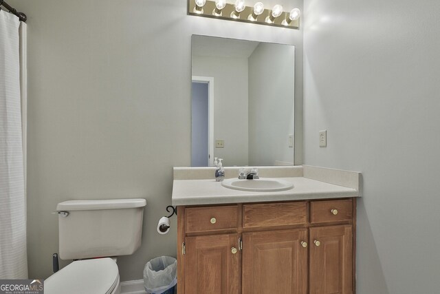 bathroom featuring toilet and vanity