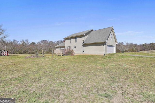 view of side of home with a deck and a yard