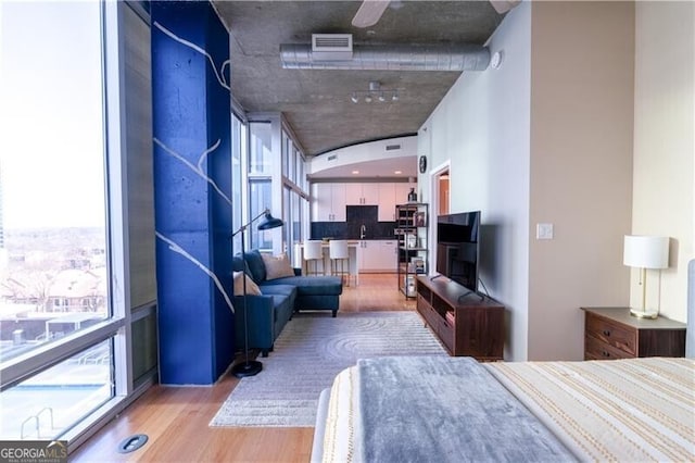bedroom with visible vents and wood finished floors