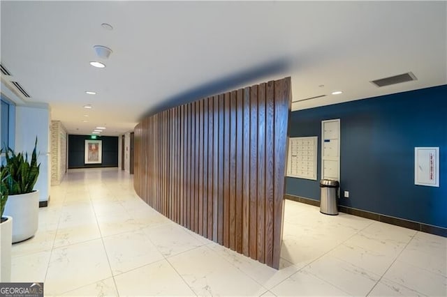 hallway with recessed lighting, visible vents, and marble finish floor