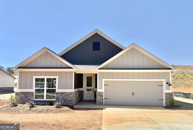 view of front facade featuring brick siding, board and batten siding, concrete driveway, roof with shingles, and a garage