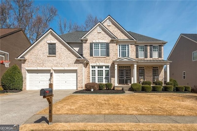 view of front facade with concrete driveway, brick siding, and a front lawn