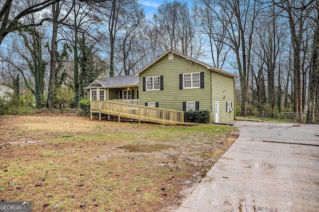 view of front of property with a deck and fence