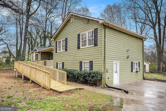 back of house with a wooden deck and cooling unit