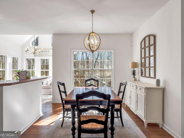 dining area with dark wood finished floors, baseboards, and a chandelier