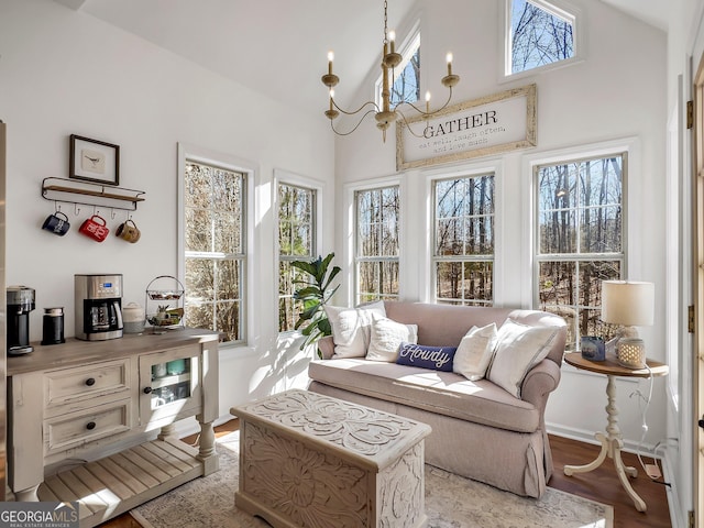 sunroom / solarium featuring a chandelier and lofted ceiling