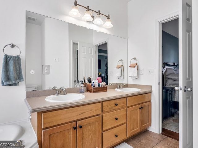 full bathroom featuring a sink, visible vents, double vanity, and tile patterned flooring