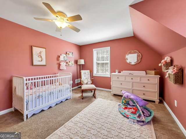 bedroom with carpet, a ceiling fan, baseboards, lofted ceiling, and a crib