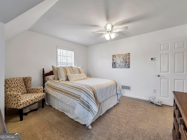 carpeted bedroom with visible vents, a ceiling fan, and baseboards