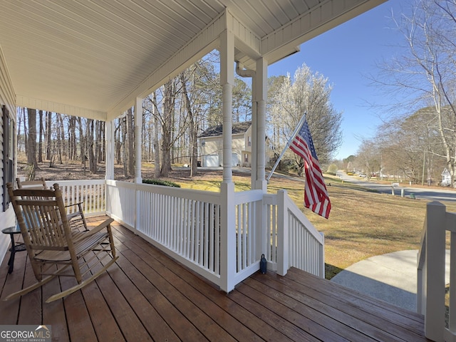 wooden deck featuring a yard