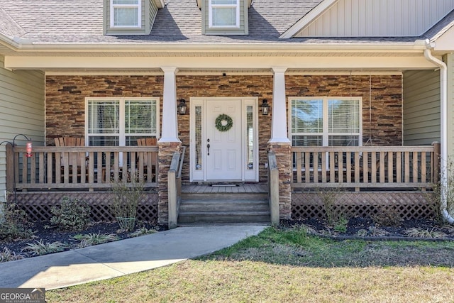 property entrance with covered porch, board and batten siding, and roof with shingles