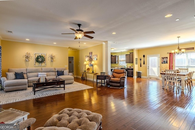 18 Vernon Rd NE, Rome, GA 30165 - living room with ceiling fan, a chandelier, baseboards, crown molding, and dark wood-type flooring