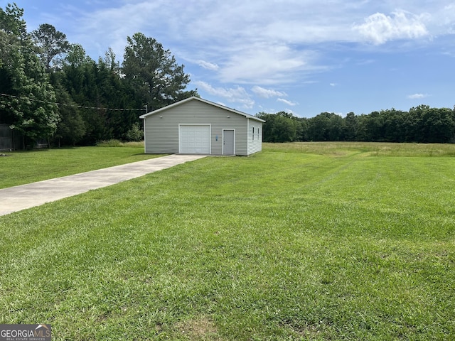 18 Vernon Rd NE, Rome, GA 30165 - view of green lawn featuring an outbuilding, a garage, and concrete driveway