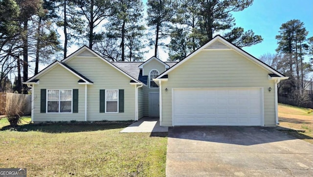 ranch-style home featuring a front yard, concrete driveway, and a garage