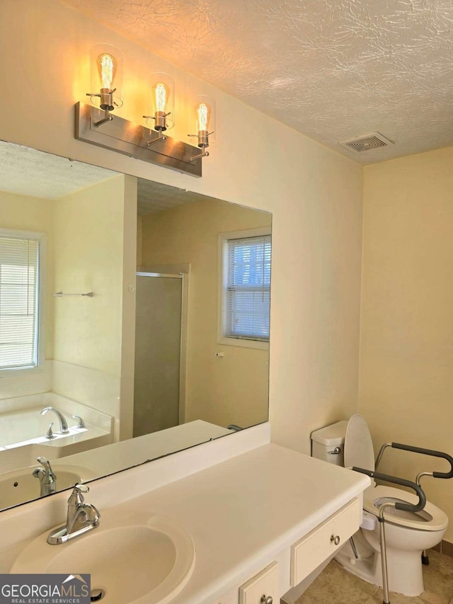 bathroom featuring visible vents, a shower stall, a textured ceiling, and toilet