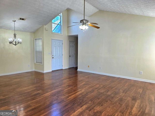 unfurnished living room with dark wood finished floors, ceiling fan with notable chandelier, visible vents, and a textured ceiling