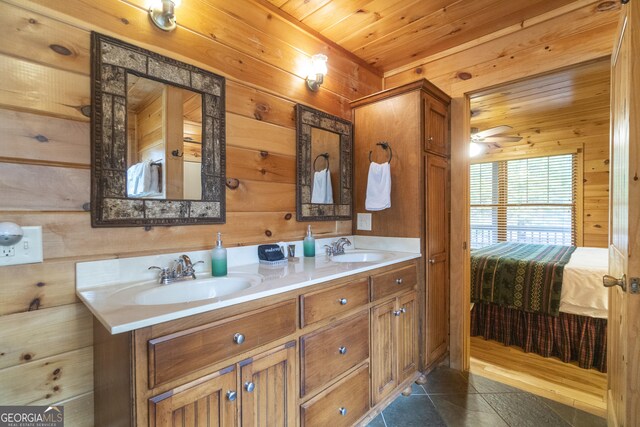 full bath with ensuite bath, wooden ceiling, wood walls, and a sink