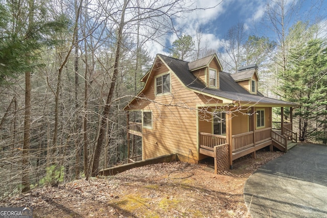 view of side of property with covered porch