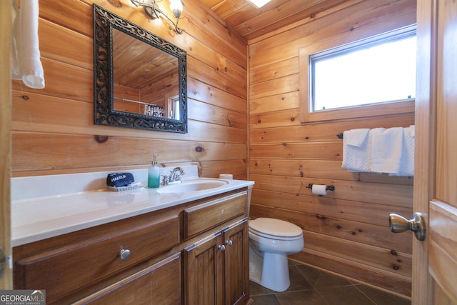 full bathroom with vanity, tile patterned flooring, wood walls, wooden ceiling, and toilet