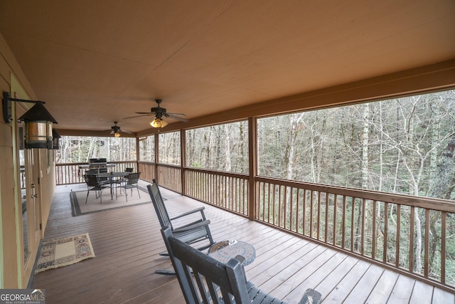 unfurnished sunroom featuring a forest view