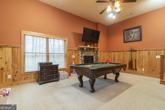 playroom featuring a wainscoted wall, a fireplace, and carpet flooring