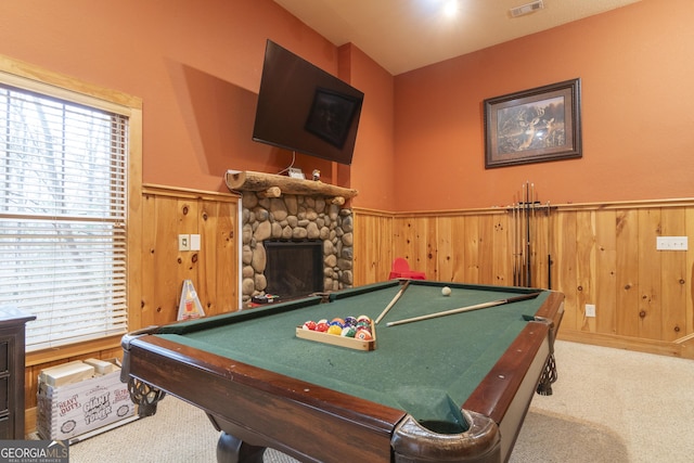 playroom with visible vents, a wainscoted wall, carpet floors, a fireplace, and wood walls