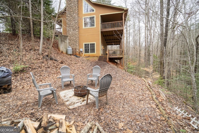 back of property with a fire pit