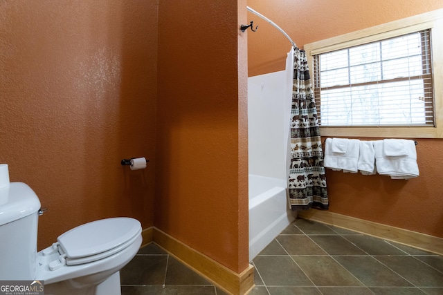 full bathroom featuring baseboards, toilet, shower / bath combo, and tile patterned flooring