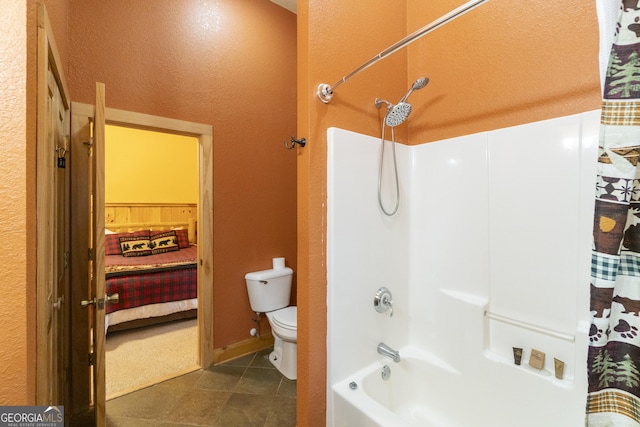 bathroom with tile patterned flooring, toilet, and shower / bathtub combination