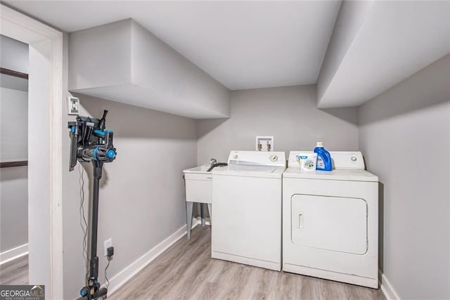 1041 Lawton Ave SW, Atlanta, GA 30310 - washroom with washer and clothes dryer, laundry area, light wood finished floors, and baseboards