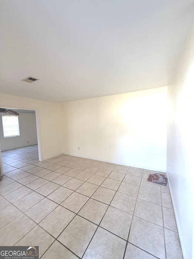 empty room with visible vents and light tile patterned flooring