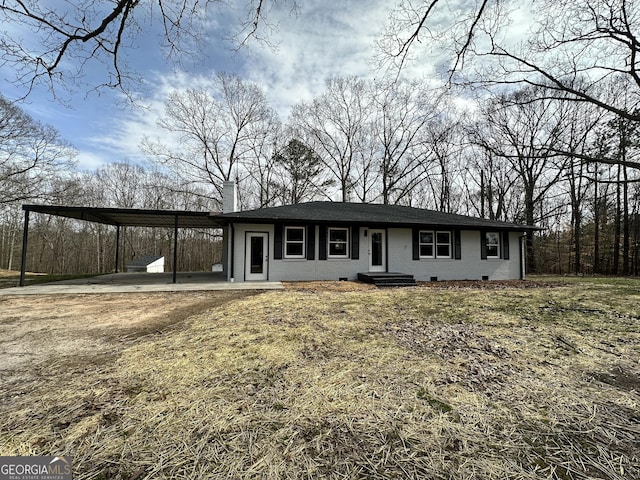 view of front of home with crawl space, brick siding, a chimney, and dirt driveway