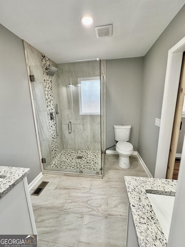 bathroom featuring visible vents, toilet, a stall shower, and vanity