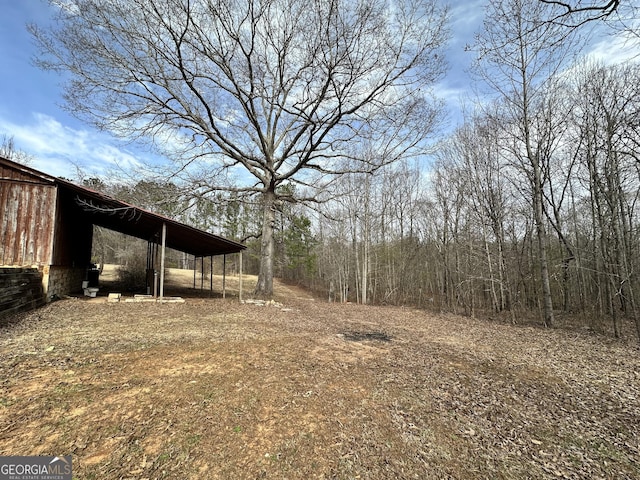 view of yard with an outdoor structure, an outbuilding, and a carport