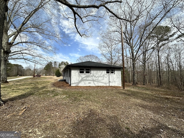 view of property exterior featuring crawl space and stucco siding