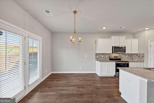 kitchen with visible vents, dark wood-style flooring, appliances with stainless steel finishes, white cabinetry, and backsplash