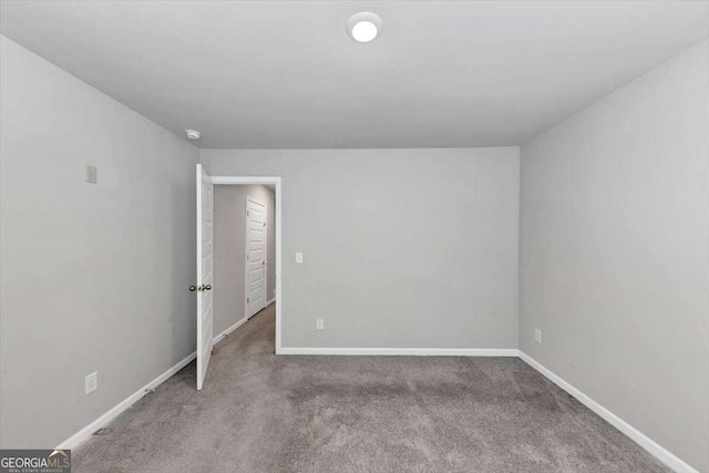 carpeted empty room with baseboards