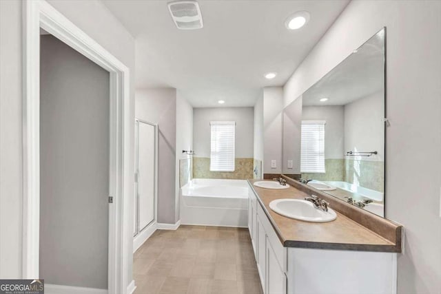 full bathroom with a bath, visible vents, a stall shower, and a sink