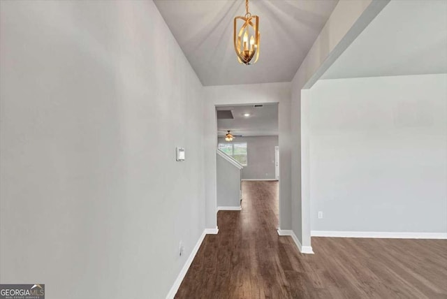 interior space with baseboards and dark wood-type flooring