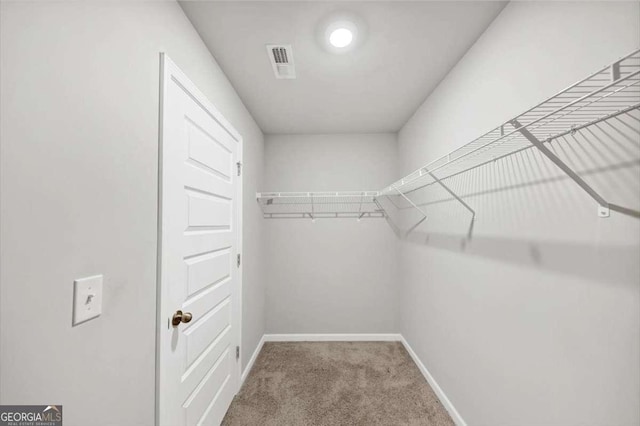 walk in closet featuring carpet flooring and visible vents