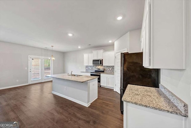 kitchen with tasteful backsplash, dark wood-style floors, white cabinets, and stainless steel appliances