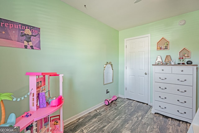 recreation room featuring wood finished floors and baseboards