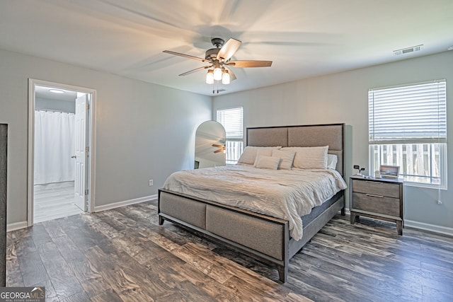 bedroom featuring ceiling fan, visible vents, baseboards, and wood finished floors