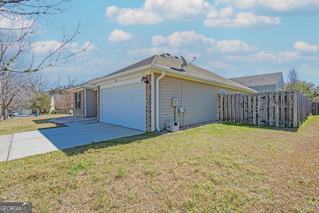 view of side of home featuring brick siding, fence, a lawn, a garage, and driveway