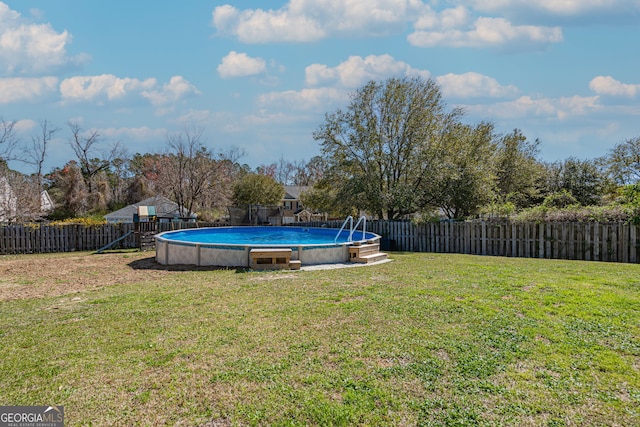 view of yard with a fenced in pool, a fenced backyard, and a playground