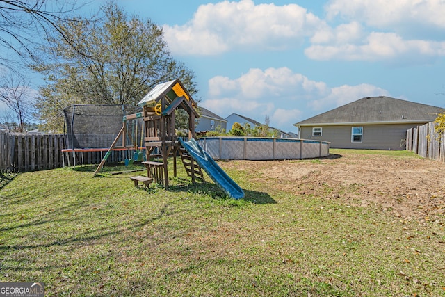 view of playground featuring a fenced in pool, a trampoline, a fenced backyard, and a lawn